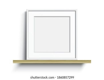 White square frame with Passepartout, standing on a wooden shelf. Blank elegant frame, vector template, with clear space for art, image, or text placement. Square shape frame, realistic vector mockup.