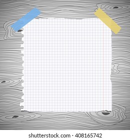 White squared notebook paper sheet, stuck on gray wooden wall, desk