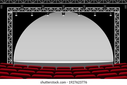 white stage with spotlight and red seats in the hall