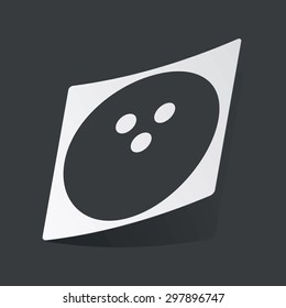 White sticker with black image of bowling ball, on black background
