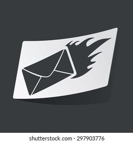 White sticker with black image of burning letter, on black background