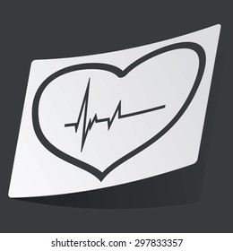 White sticker with black image of cardiogram in heart contour, on black background