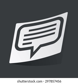 White sticker with black image of chat bubble with text, on black background