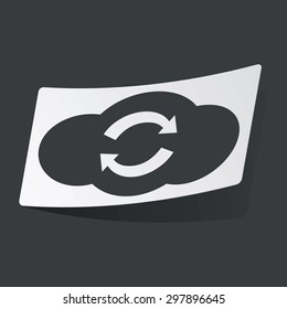 White sticker with black image of cloud and exchange symbol, on black background