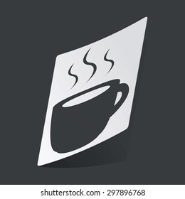 White sticker with black image of cup with hot drink, on black background