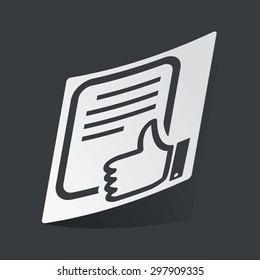 White sticker with black image of document page with like symbol, on black background