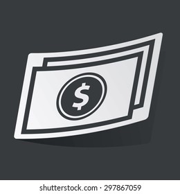 White sticker with black image of dollar banknote, on black background