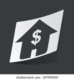 White sticker with black image of house with dollar symbol, on black background
