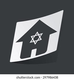 White sticker with black image of house with Star of David, on black background