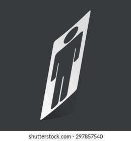 White sticker with black image of man symbol, on black background