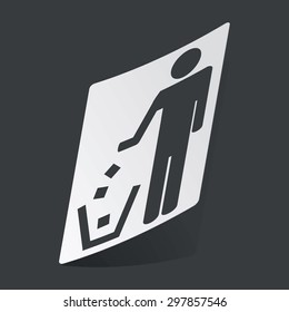 White sticker with black image of man throwing garbage, on black background