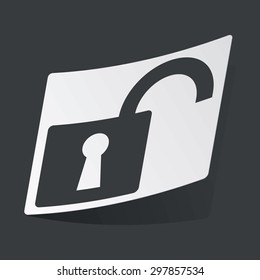 White sticker with black image of open padlock, on black background