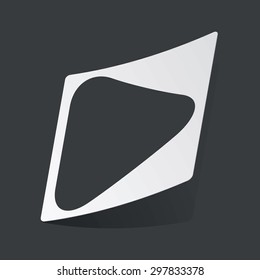 White sticker with black image of play button, on black background