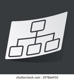 White sticker with black image of scheme, on black background