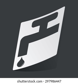 White sticker with black image of tap and water drop, on black background