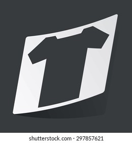 White sticker with black image of T-shirt, on black background