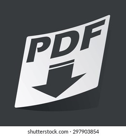 White sticker with black text PDF and down arrow, on black background