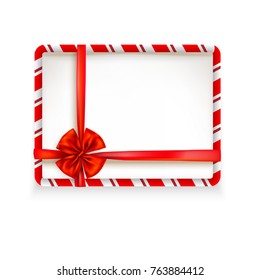 White stripe Christmas frame tied with a red shiny ribbon bow. Design element for Christmas, birthday, anniversary, new year, party or other celebrations and events. Place for text.