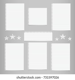 White striped note, notebook paper for message or text stuck on gray background with stars.