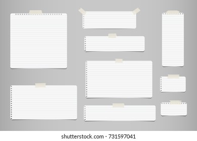 White striped note, notebook paper for message or text stuck with sticky tape on gray background.
