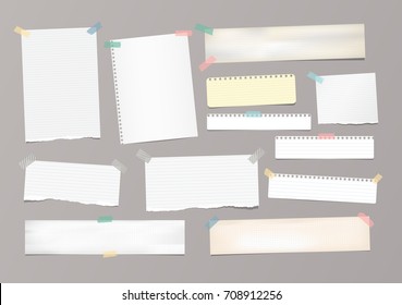 White striped note paper, copybook, notebook sheet stuck with adhesive tape on gray background.