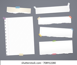 White striped note paper, copybook, notebook sheet stuck with adhesive tape on dark gray background.