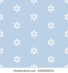 White stylized snowflakes on blue background. Abstract vector seamless pattern. Classical ornament.