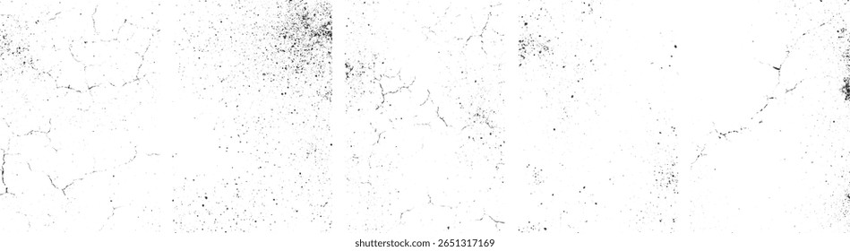 Uma superfície branca com uma textura aflita apresentando rachaduras pretas e manchas escuras dispersas.