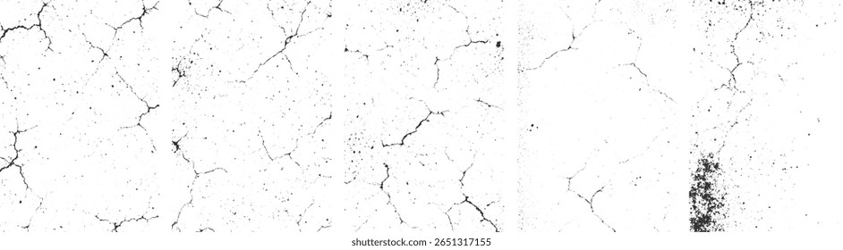 Uma superfície branca com rachaduras pretas dispersas e manchas criando um padrão texturizado.