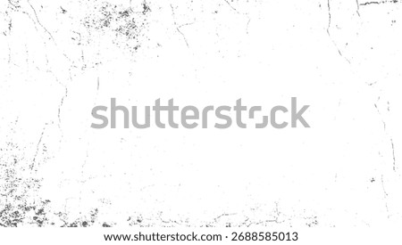 A white surface with scattered dark gray irregular shapes and thin linear markings.