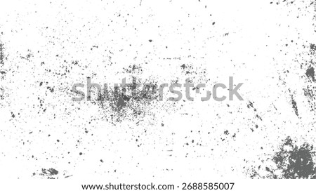 A white surface with scattered gray specks and clusters of varying sizes.