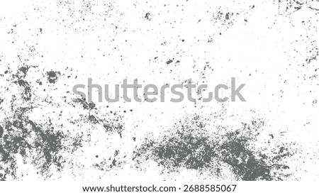 A white surface with scattered gray specks and clusters of irregular shapes.