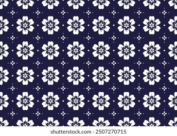 White symbol floral on dark blue background, ethnic fabric seamless pattern design for cloth, carpet, batik, wallpaper, wrapping etc.