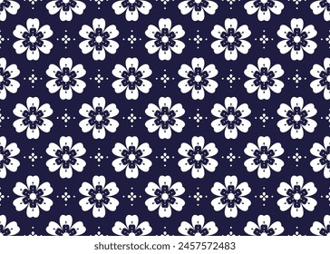 White symbol flowers on dark blue background, ethnic fabric seamless pattern design for cloth, carpet, batik, wallpaper, wrapping etc.