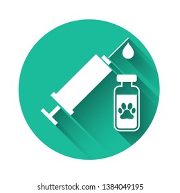 White Syringe with pet vaccine icon isolated with long shadow. Dog or cat paw print. Green circle button. Vector Illustration