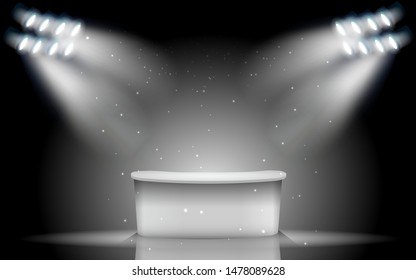 white table with white spotlight on the stage