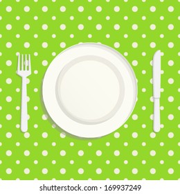 White tableware on the green tablecloth: plate, fork and knife. Seamless design pattern.