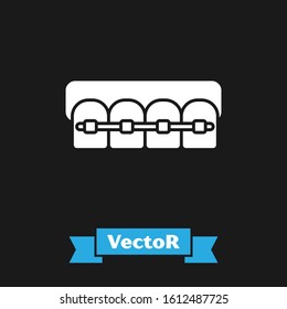 White Teeth with braces icon isolated on black background. Alignment of bite of teeth, dental row with with braces. Dental concept.  Vector Illustration