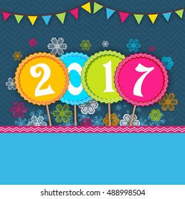 White text 2017 in colorful circles on snowflakes and buntings decorated background, Elegant greeting card for Happy New Year celebration.