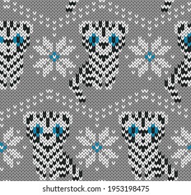 White tiger with blue eyes jacquard knitted seamless pattern. Winter background with cute animals symbol of New year 2022. Vector illustration.