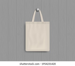 White tote on wood wall. Mockup of eco canvas bag with handle. Cotton fabric tote. Reusable cloth of ecobag for shopping, grocery, market, beach. Realistic fashion handbag. Template of design. Vector.