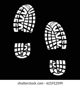 White tracks from shoes on a black background
