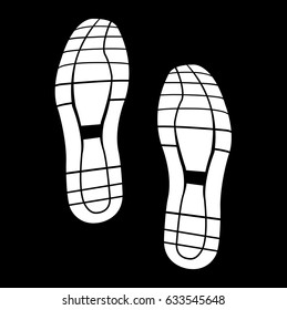 White tracks from shoes on a black background