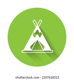 White Traditional indian teepee or wigwam icon isolated with long shadow background. Indian tent. Green circle button. Vector