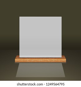 White translucent frame on a wooden shelf on a dark background.