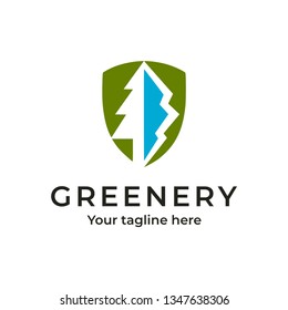 White tree and blue mountain in a green shield. Outdoor adventure logo