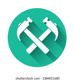 White Two crossed hammers icon isolated with long shadow. Tool for repair. Green circle button. Vector Illustration