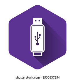 White USB flash drive icon isolated with long shadow. Purple hexagon button. Vector Illustration