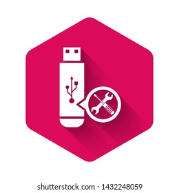 White USB flash drive with screwdriver and wrench icon isolated with long shadow. Adjusting, service, setting, maintenance, repair, fixing. Pink hexagon button. Vector Illustration