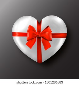 White Valentine's day heart with red bow on black background